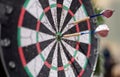 Two darts sticking out of wooden target closeup