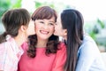 Two daughters kiss mom at home Royalty Free Stock Photo