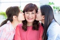 Two daughters kiss mom at home Royalty Free Stock Photo
