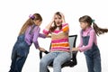 Two daughters unwind mom in an office chair