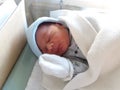 Two days old newborn baby boy, sleeping in hospital cot Royalty Free Stock Photo