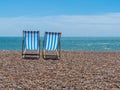 Two Deck Chairs on a Beach