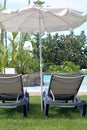 Two deck chairs under umbrella. Canary Islands.Spain.Canary Islands.Spain. Royalty Free Stock Photo