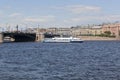 Two-deck motor ship Moscow-55 runs along the Neva River against the background of the Exchange Bridge and Mytninskaya Embankment i