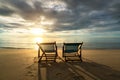 Two deckchairs on the beach at sunset with a tropical sea background. Travel and Vacation in Summer at sea Royalty Free Stock Photo