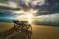 Two deckchairs on the beach at sunset with a tropical sea background. Travel and Vacation in Summer at sea Royalty Free Stock Photo