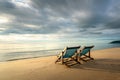 Two deckchairs on the beach at sunset with a tropical sea background. Travel and Vacation in Summer at sea Royalty Free Stock Photo