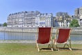 two deckchairs empty set in the grass on the banks of The Seine river in Paris Royalty Free Stock Photo