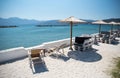 Parasols and sun loungers on beach