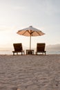 Two deckchairs on a white sandy beach