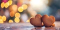 Two Decorated Gingerbread hearts on empty wooden table