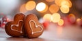 Two Decorated Gingerbread hearts on empty wooden table