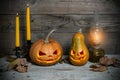 Two decorated pumpkins for a Halloween on a mystical autumn background Royalty Free Stock Photo