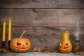 Two decorated pumpkins for a Halloween on a mystical autumn background with candles Royalty Free Stock Photo