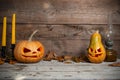 Two decorated pumpkins for a Halloween on a mystical autumn background with candles and gas lamp Royalty Free Stock Photo
