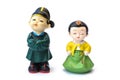 Two decorative ceramic Korean figures, man and woman, standing in line in traditional colorful clothes Han bock. Royalty Free Stock Photo