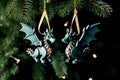 Two decorative toy dragons made of wood hang on rope decorating Christmas tree