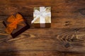 Two decoratively wrapped gifts on a wooden table