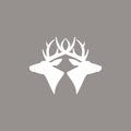 Two deer heads logo. vector flat silhouette isolated on beige background. Wild animal symbol Royalty Free Stock Photo