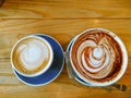 Two Coffees on a Honey Colored Table Royalty Free Stock Photo