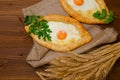 Two delicious khachapuri with wheat ears on sacking Royalty Free Stock Photo