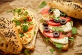 Two delicious sandwiches with hummus, tomato, mozarella cheese, herbs and olives