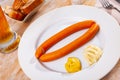 Two sacher sausages served as beer snack with horseradish and mustard