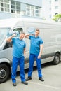 Two Delivery Men Delivering Bottles Of Water Royalty Free Stock Photo