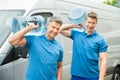 Two Delivery Men Delivering Bottles Of Water Royalty Free Stock Photo