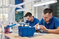 Two dental technicians working in a dental laboratory. Dental implant manufacturing process Royalty Free Stock Photo