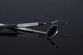 Two Dental Tools , Dental mirror and probe on Black background Royalty Free Stock Photo