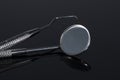 Two Dental Tools , Dental mirror and probe on Black background Royalty Free Stock Photo