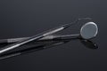 Two Dental Tools , Dental mirror and probe on Black background Royalty Free Stock Photo