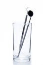 Two Dental Tools in the glass : Dental mirror and probe