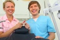Two dentists sit in cabinet of dental clinic