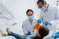 Two dentists wearing sterile masks