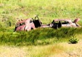 Old junk cars on hillside.