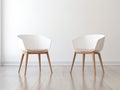 Two designer chairs elegantly positioned in the middle of a room, interior design sophistication Royalty Free Stock Photo