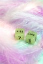 Two dice for erotic sexual game with the text Kiss lips for Valentines Day sex,romantic, sensual concept with pastel colored Royalty Free Stock Photo