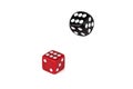 Two dice isolated on a white background. Red lies like six, and black flies in the air. Royalty Free Stock Photo