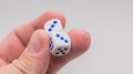 Two dice with numbers three in hand. Royalty Free Stock Photo