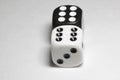 Two dice on a white background. White and black dice on a white background. Royalty Free Stock Photo