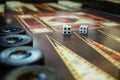 Dices on a backgammon board game, closeup shot Royalty Free Stock Photo