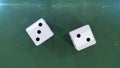 Two dices on a green background showing a five