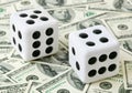 Two dices on money background Royalty Free Stock Photo