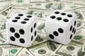 Two dices on money background Royalty Free Stock Photo