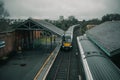 Two diesel trains are crossing at ballymoney train station in northern ireland. Looking towards the trains and train tracks from