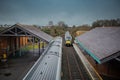 Two diesel trains are crossing at ballymoney train station in northern ireland. Looking towards the trains and train tracks from