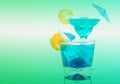 Two different blue cocktails with lemon and ice cubes, refreshing alcoholic drinks based on vodka and blue liqueur Royalty Free Stock Photo