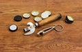 Two different bottle openers among of bottle caps on table Royalty Free Stock Photo